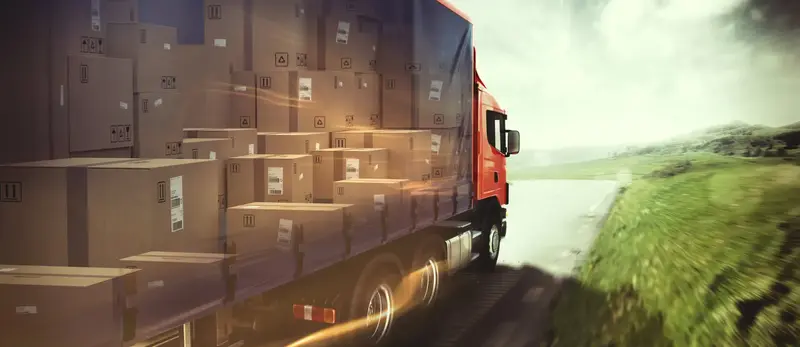 A moving truck driving on a country highway