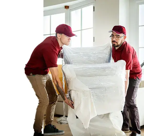 Two removalists carrying an armchair wrapped in protective plastic